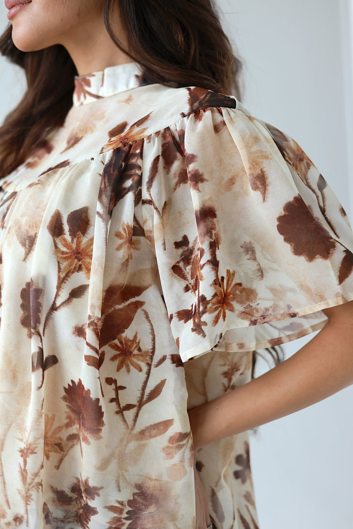 Close-up of the Florence floral mockneck blouse with flutter sleeves and botanical print
