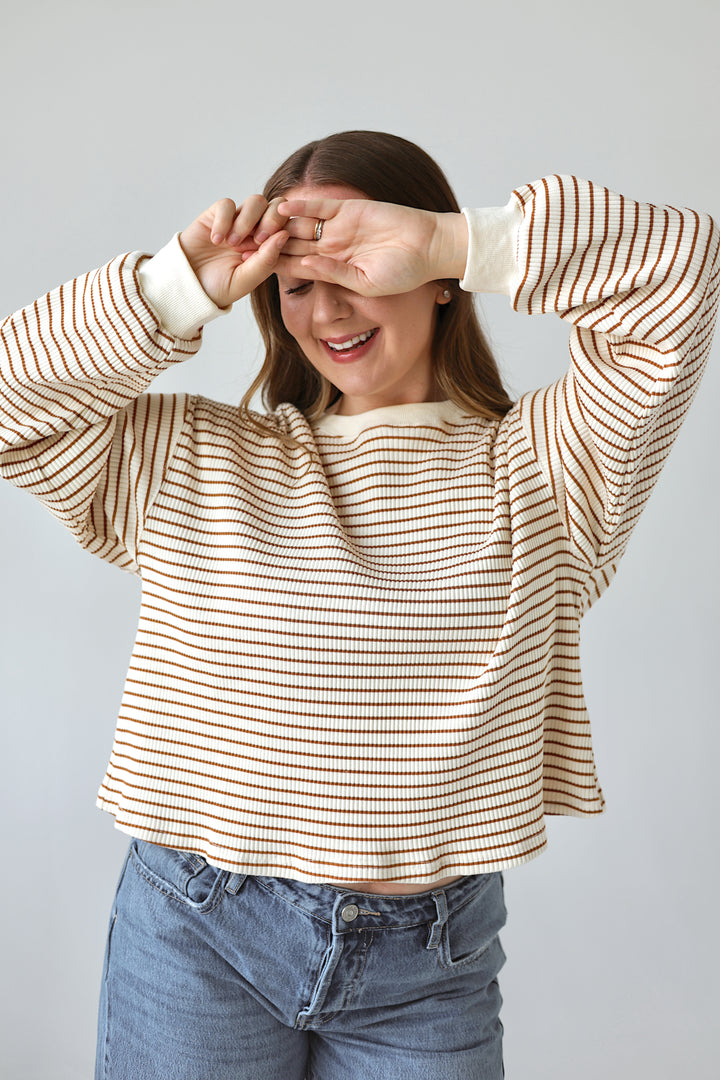 Model wearing the Alessia cream and brown striped ribbed long sleeve top