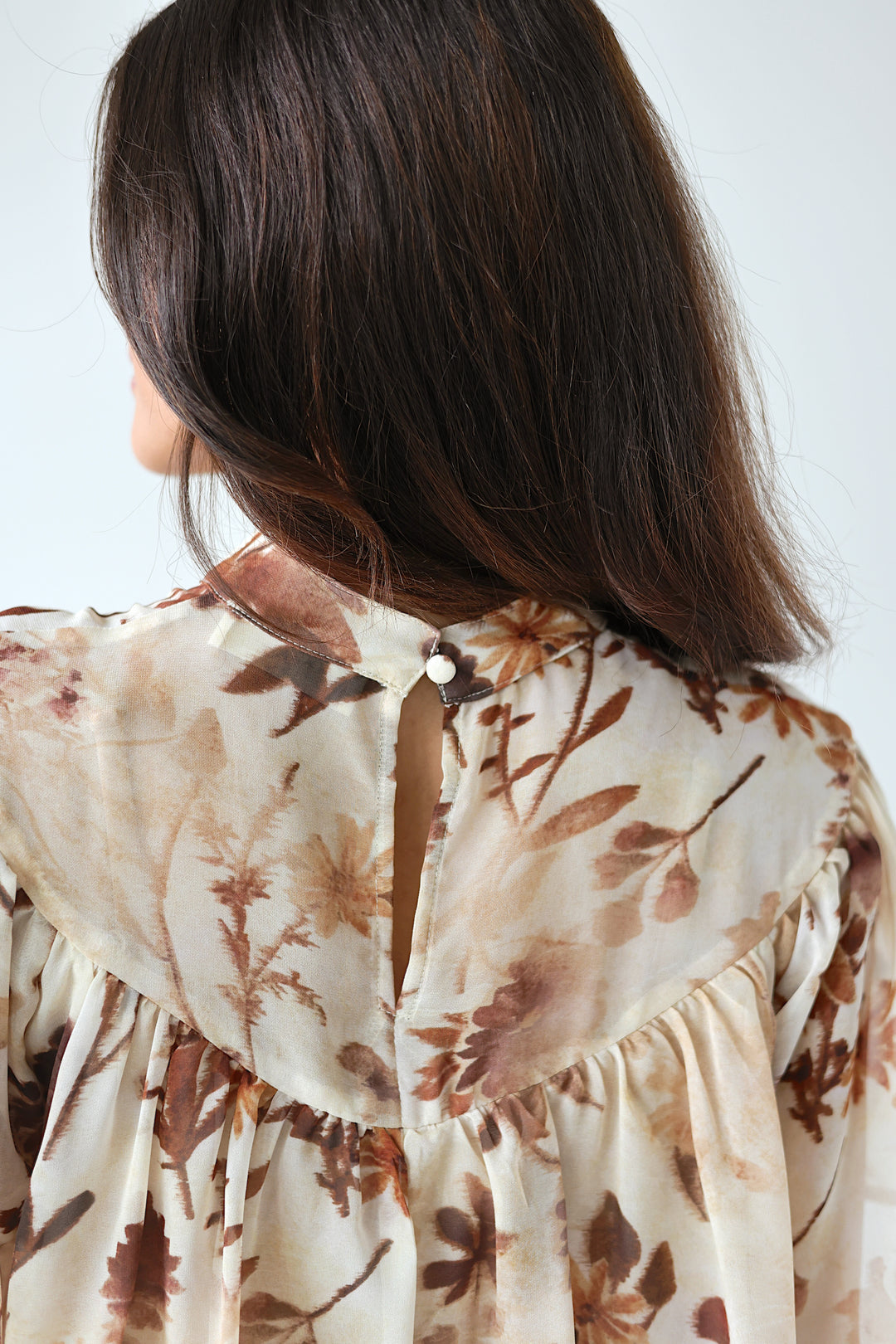 Close-up back view of the Florence floral blouse showing gathered ruffle detailing
