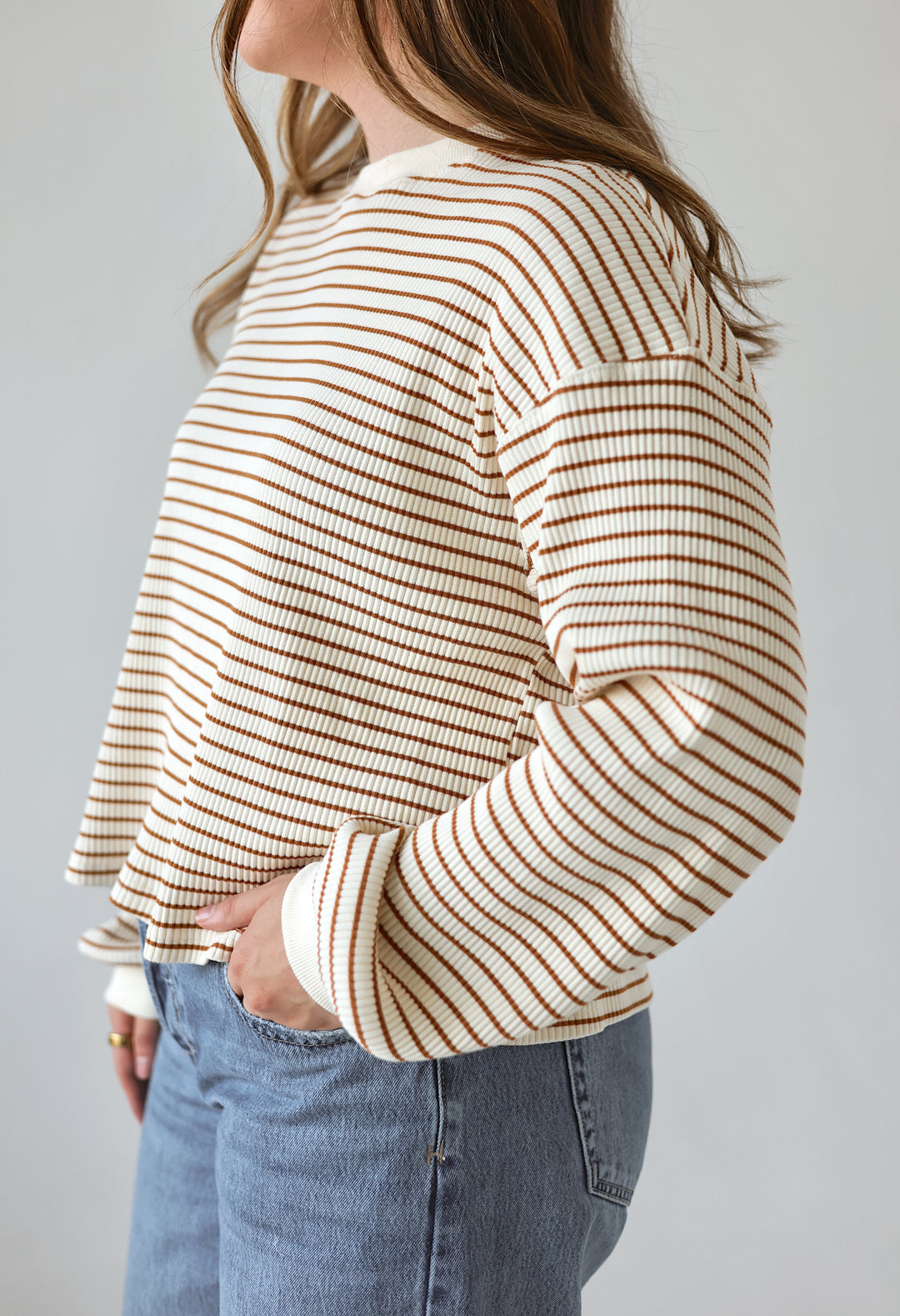 Side view of the Alessia cream and brown striped long sleeve top