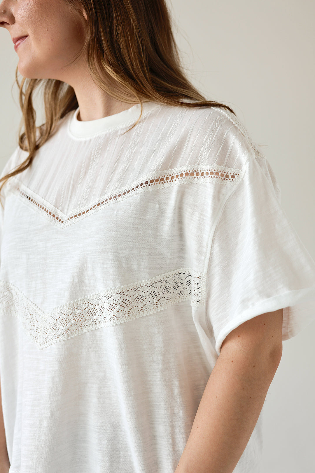 Side view of the Camille white lace detail top with relaxed short sleeves