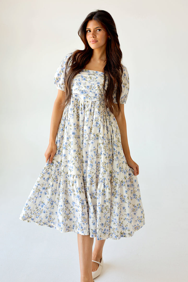 Woman wearing a floral dress against a white background