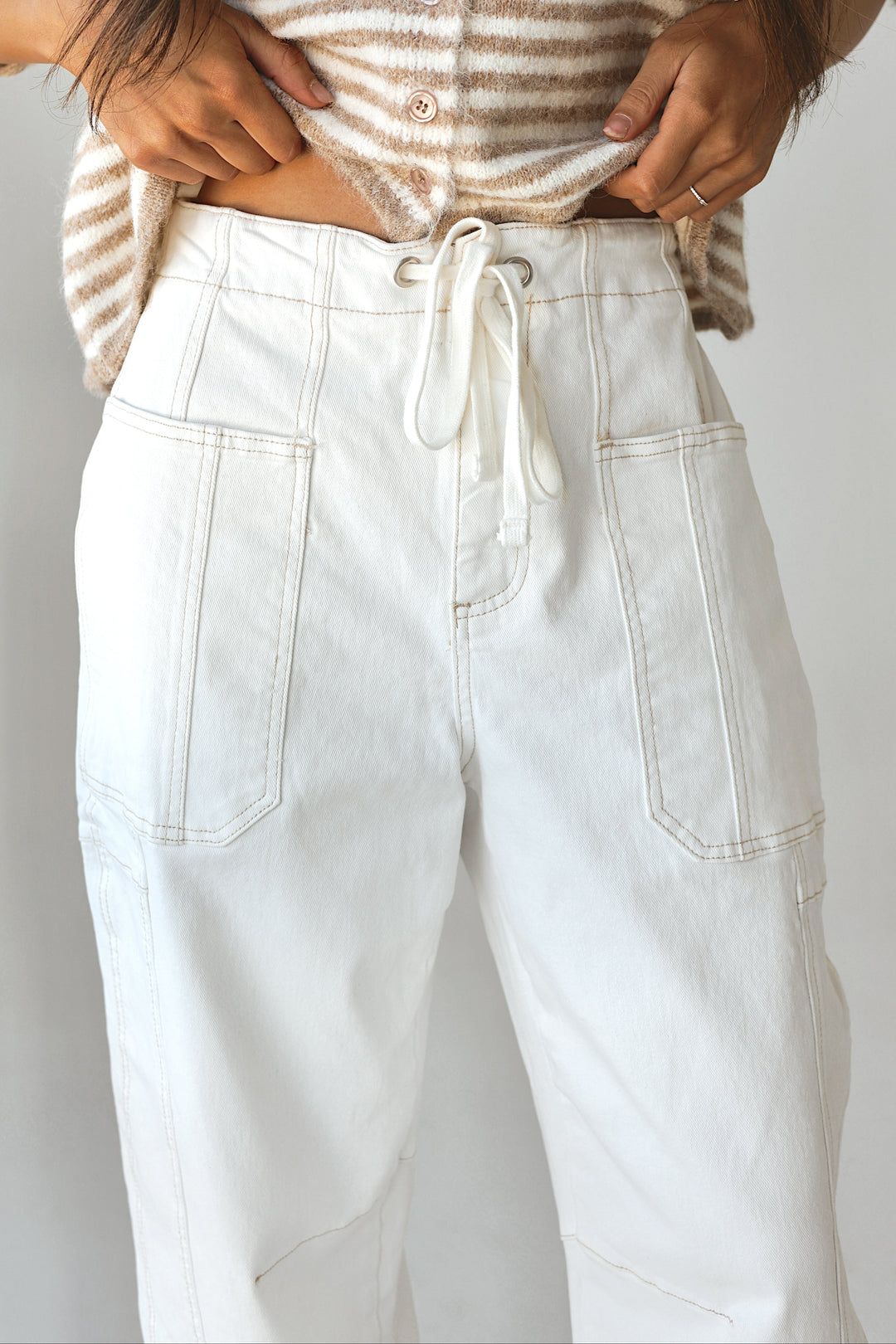 Bacio & Co. white barrel denim pants with drawstring waist, close-up detail front view