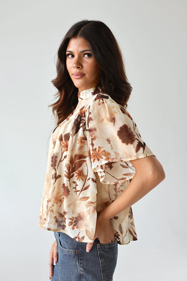 Side view of the Florence floral blouse with flutter sleeves and flowy fit