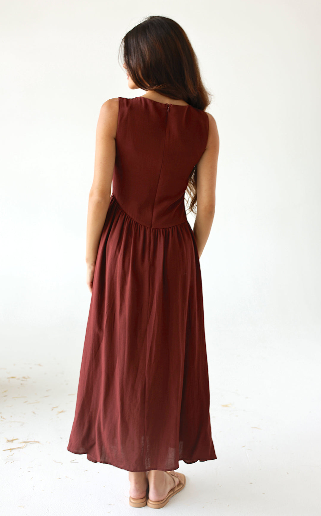 Burgundy sleeveless midi dress with drop waist and feminine button detailing