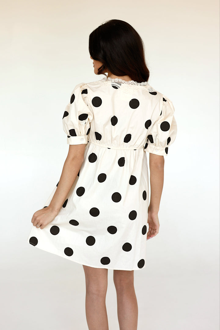 Back view of the Colette ivory and black polka dot mini dress