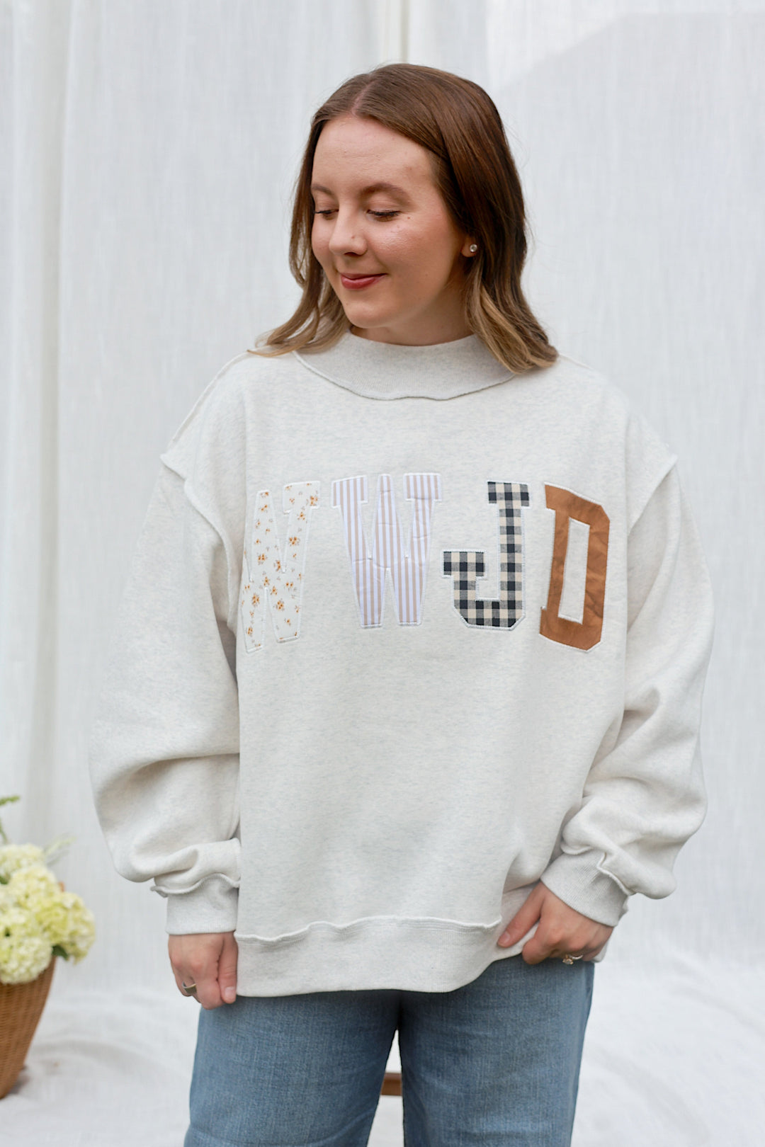 Model wearing the ash grey WWJD embroidered mockneck sweatshirt, front view.