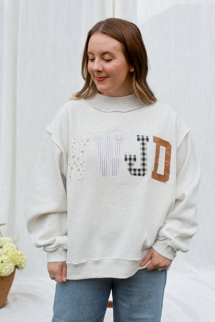 Model wearing the ash grey WWJD embroidered mockneck sweatshirt, front view.