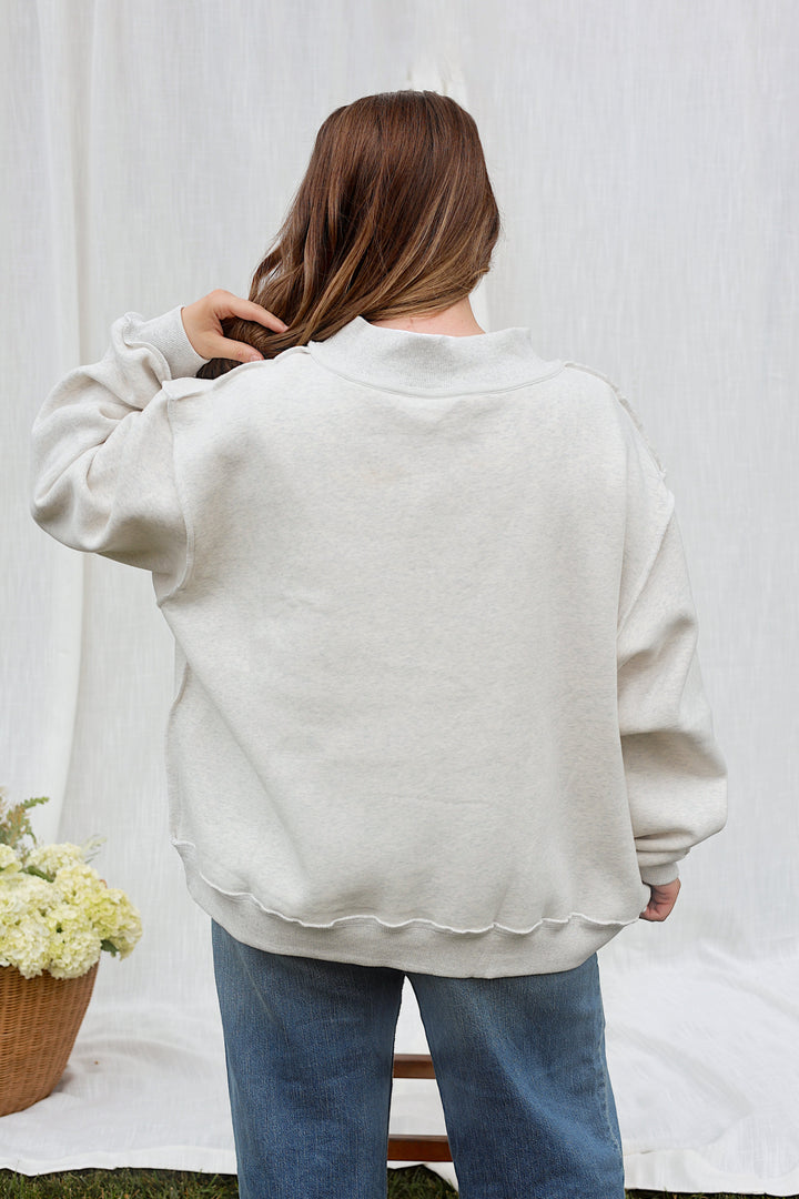 Back view of model wearing the oversized ash grey WWJD mockneck sweatshirt.