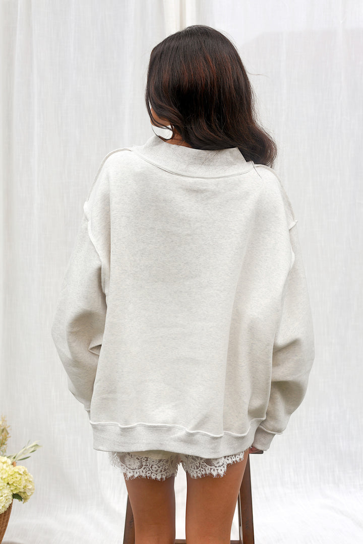 Back view of the oversized ash grey PRAY mockneck sweatshirt.